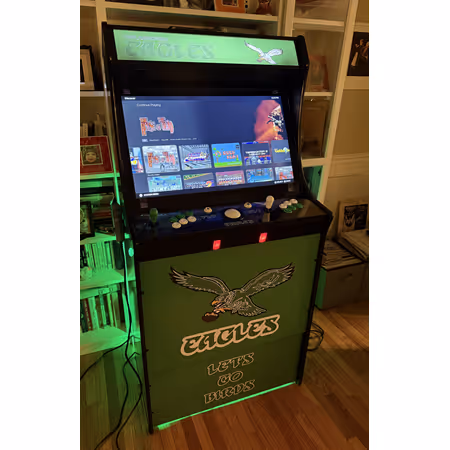 Black arcade machine displaying a game menu screen with retro game titles listed on top panel.